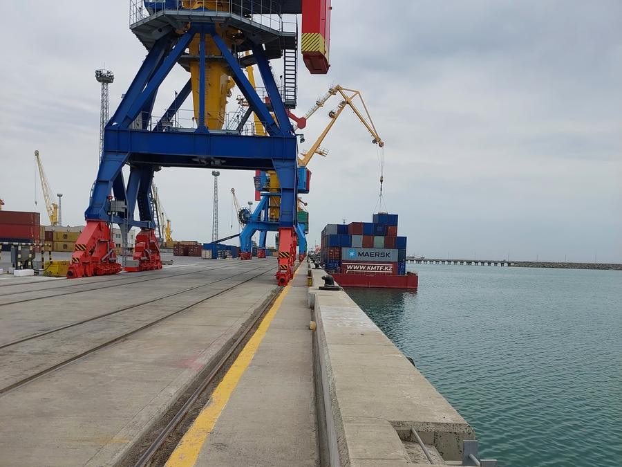 Port crane on a quay with rail lines